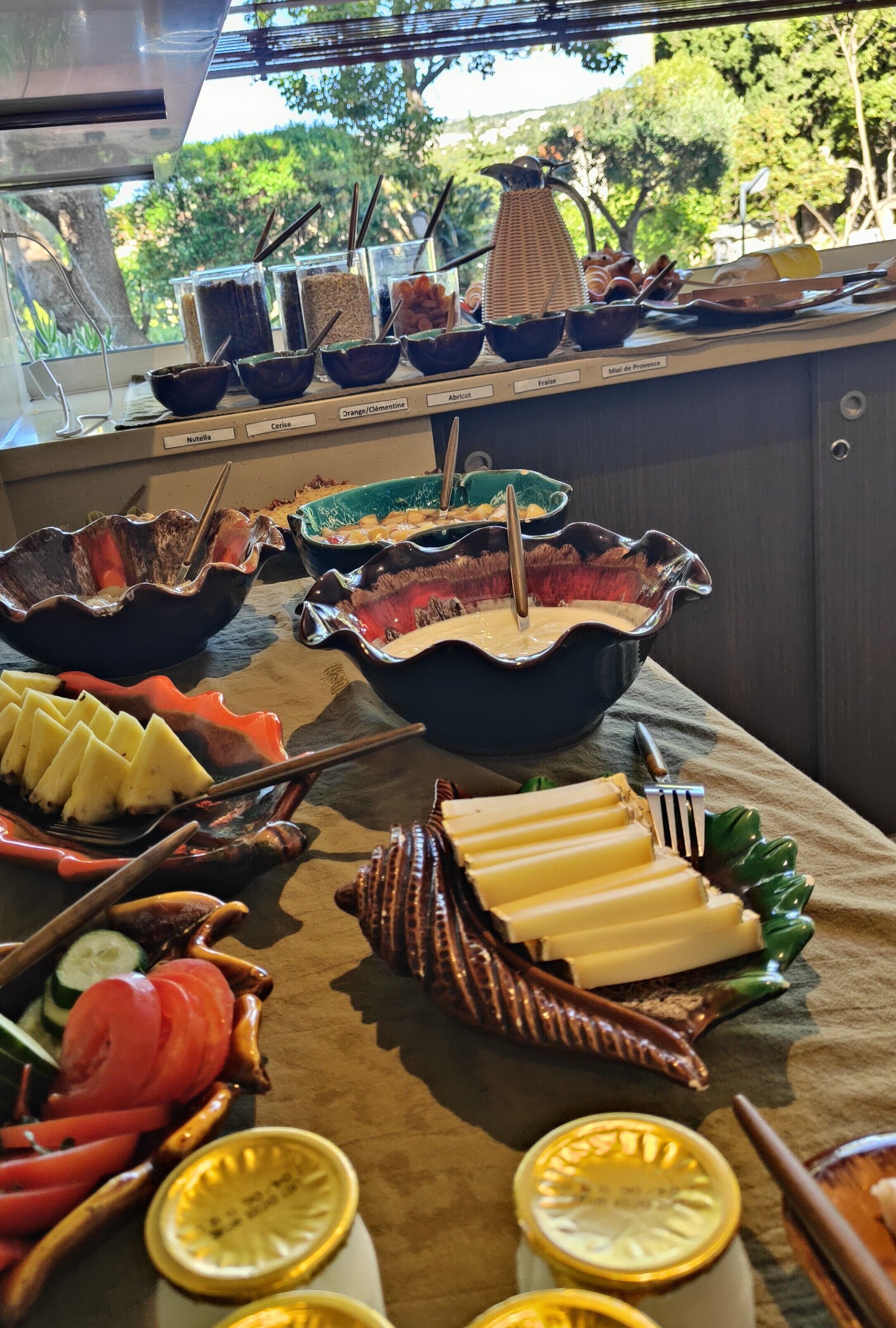 A buffet with various food items and utensils.