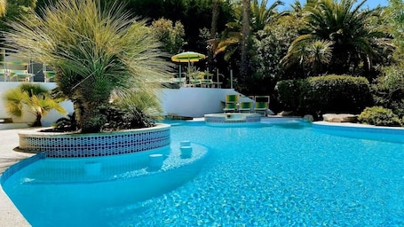 Seasonal outdoor pool, open 9:00 AM to 8:30 PM, pool umbrellas