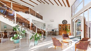 A spacious lobby with a staircase, seating area, and large windows. - Best Western Domaine de Roquerousse (Salon-de-Provence)