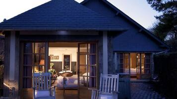 A house with a covered porch, a bed, and a dining area.