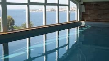 Indoor pool, open 9:30 AM to 9:00 PM, pool loungers