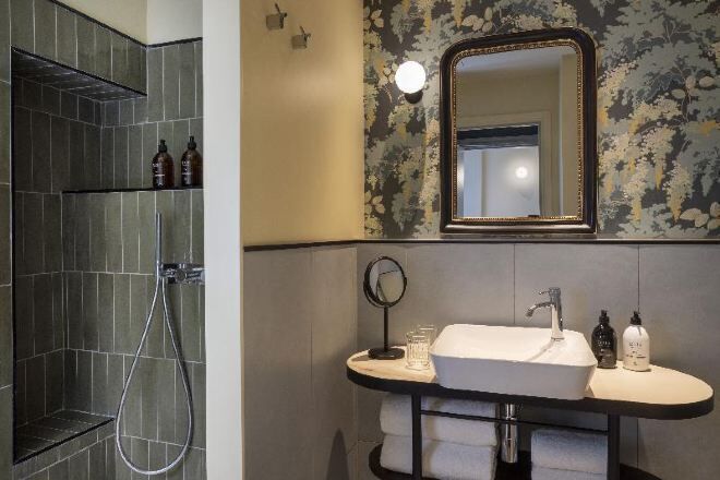 Bathroom | Designer toiletries, hair dryer, slippers, towels