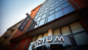 A hotel sign with the name 'TRIUM'.