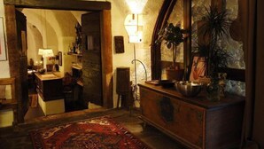 A cozy room with a wooden dresser, a mirror, a rug, and a lamp. - Romanda (Levico Terme)