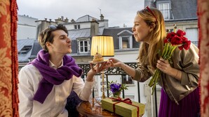 A man and a woman on a balcony with a lamp, a gift box, and flowers. - Hotel de Seine (Paris)