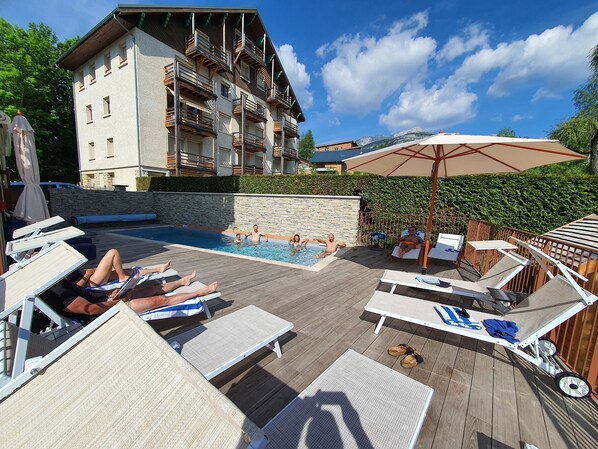 Seasonal outdoor pool, pool umbrellas, pool loungers