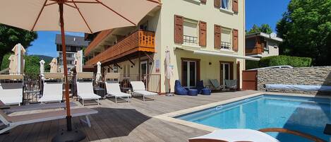 Seasonal outdoor pool, pool umbrellas, pool loungers