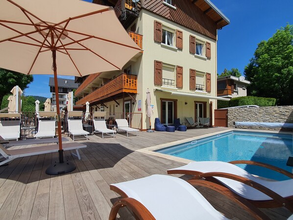 Seasonal outdoor pool, pool umbrellas, pool loungers