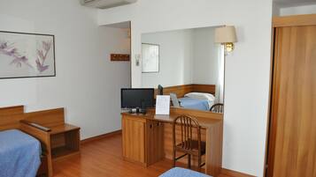 Triple Room | Minibar, in-room safe, desk, cots/infant beds
