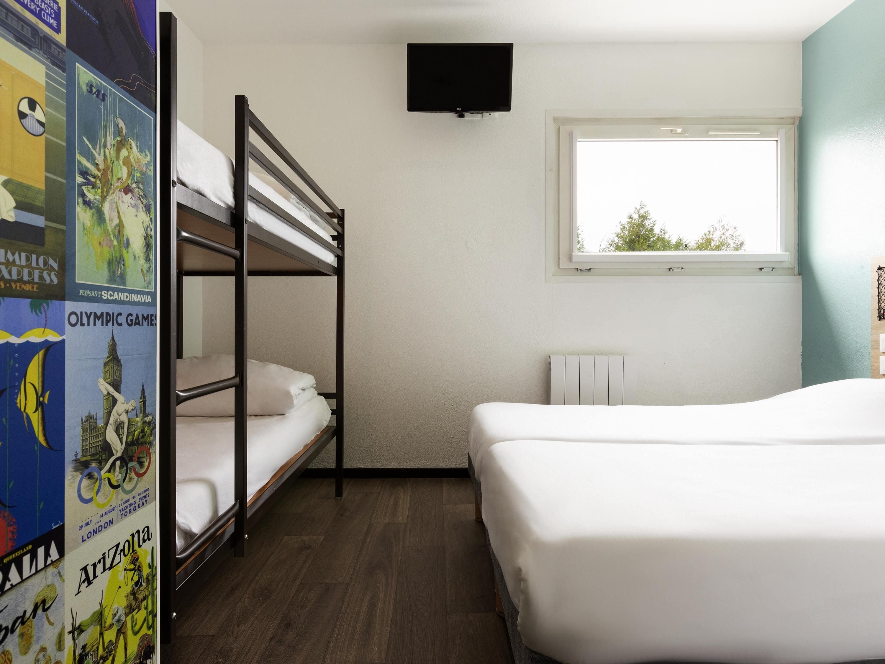 Una habitación con literas, ventana con vistas, televisor de pantalla plana y radiador.