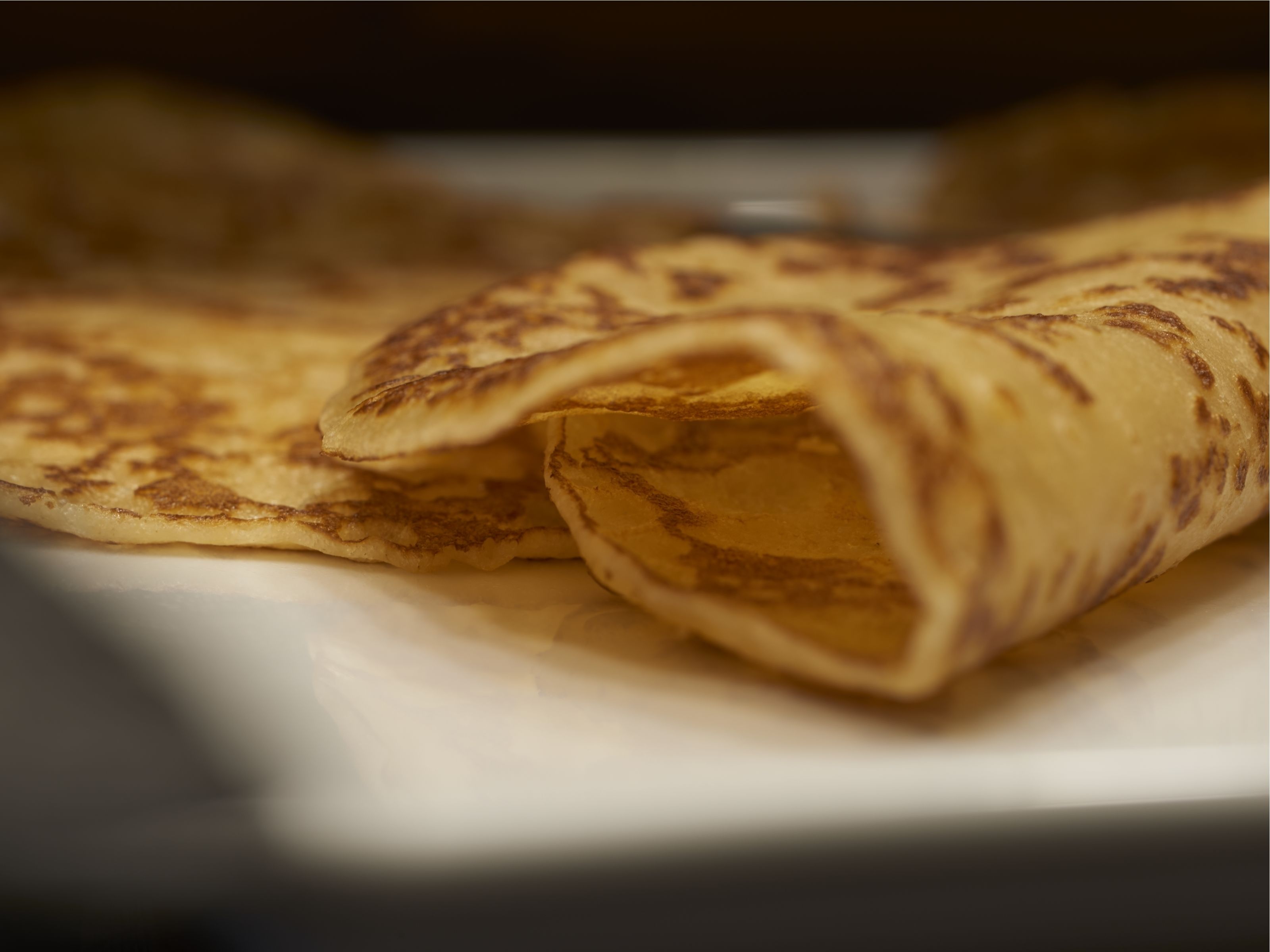 A plate with rolled crepes.