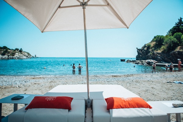 On the beach, beach umbrellas, beach towels, beach volleyball