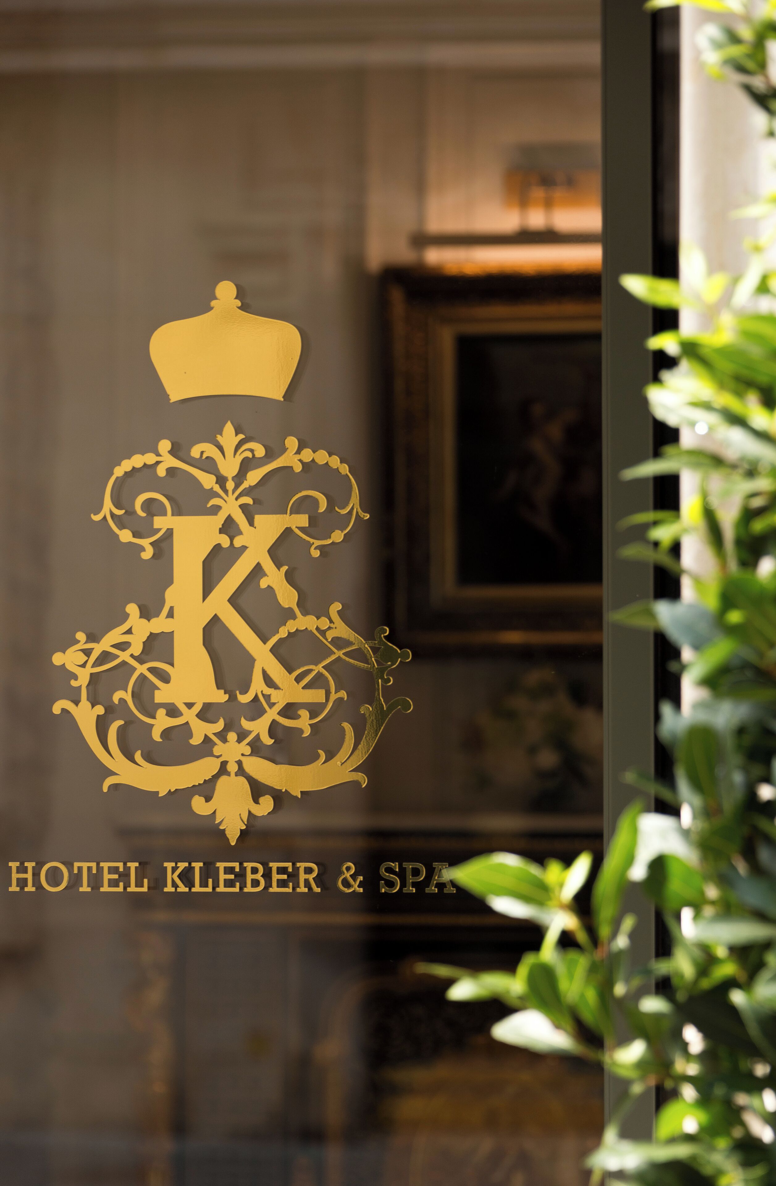 A logo with a crown and the letter "K" in a decorative font, with the text "HOTEL KLEBER & SPA" below.