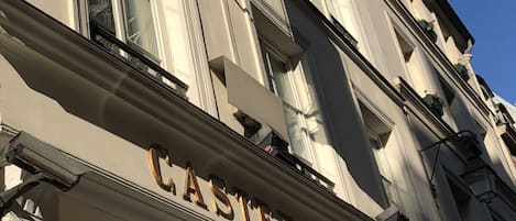 The exterior of the Castex Hotel with a prominent sign and a clear view of the entrance.
