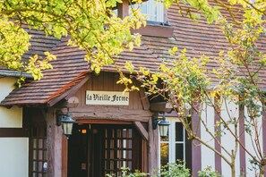 A traditional building with a sign reading 'La Vieille Ferme.'