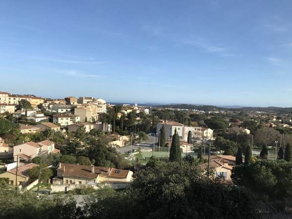 A coastal town with traditional Mediterranean architecture, including terracotta-roofed buildings and narrow streets. - Hôtel Paradis (Bormes-Les-Mimosas)
