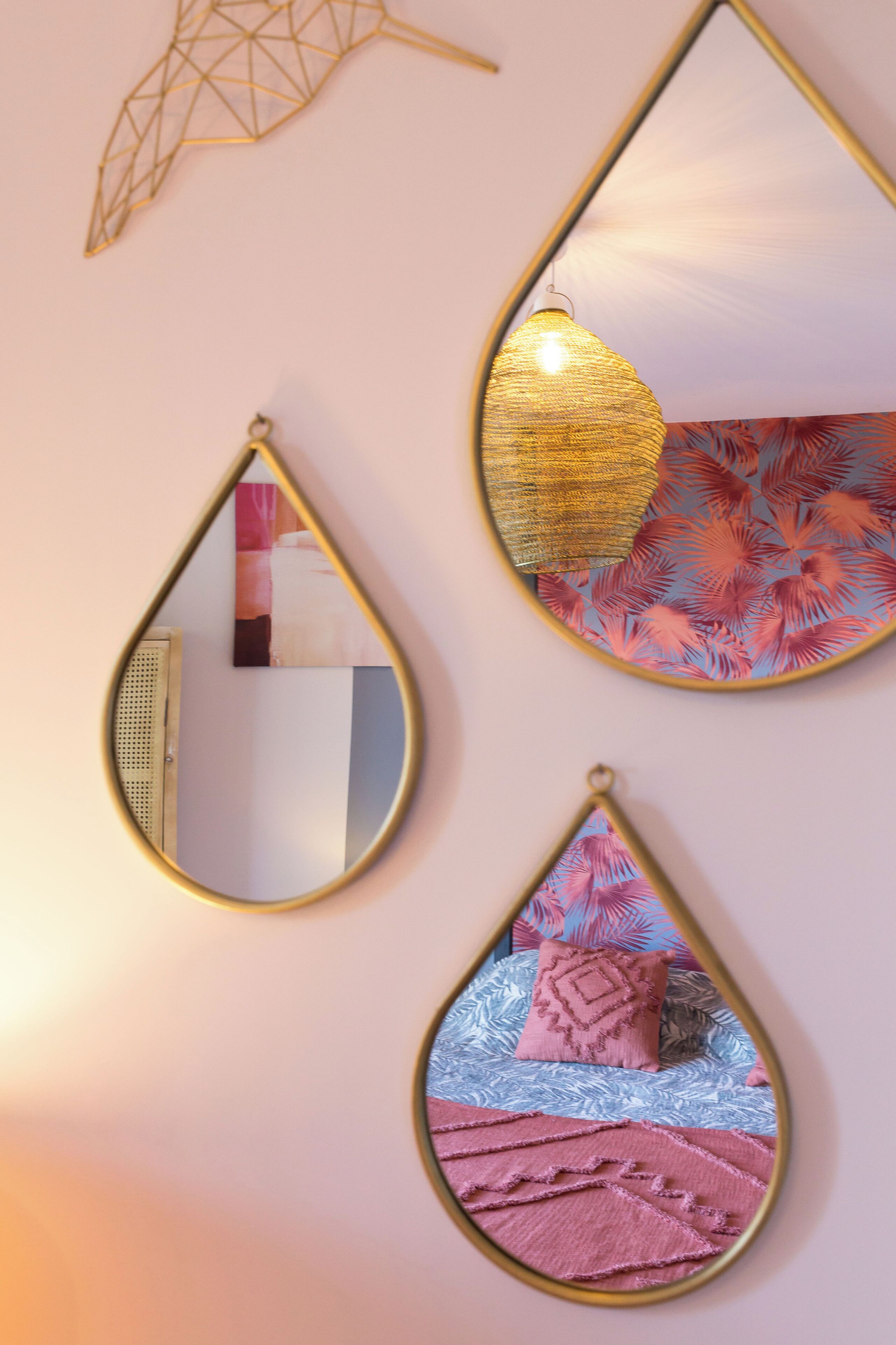 Three wall-mounted mirrors with different designs.
