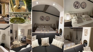 Un hôtel doté d’un patio, d’une table à manger, d’un lavabo vert, d’un grand lit avec plusieurs oreillers, d’un canapé et d’un miroir.