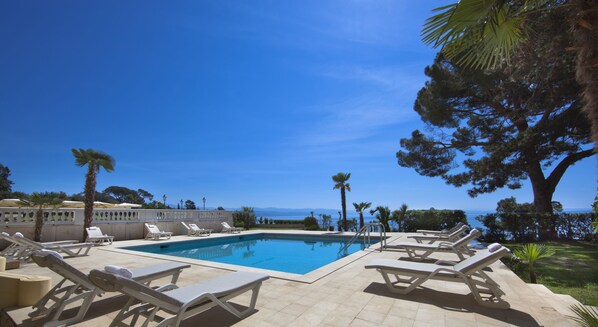 Seasonal outdoor pool, open 8:00 AM to 8:00 PM, pool umbrellas