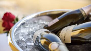 A close-up of a wine bottle with a label, resting on ice.
