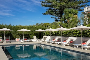 Outdoor pool, open 9:00 AM to 7:00 PM, pool umbrellas, pool loungers