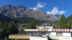 A hotel named "HOTEL ASTORIA" with a view of mountains in the background. - Astoria (Leukerbad)