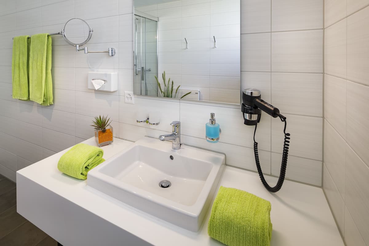 shower, hair dryer, towels, soap