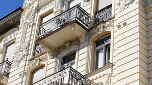 A building with ornate architectural details, including decorative balconies and intricate carvings. - Hotel Victoria au Lac (Paradiso)