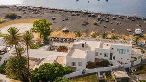 A coastal area with buildings, a beach, and boats.