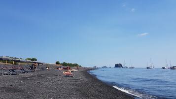 On the beach, black sand