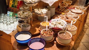 A buffet with various food items and beverages.