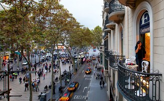 A busy urban street with pedestrians, a bus lane, and a building with a sign reading "Continental".