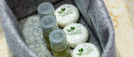 A container with various skincare products, including bottles and soap bars.