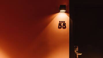 A wall-mounted sign indicating "ROOM 55" with a door handle to the right.
