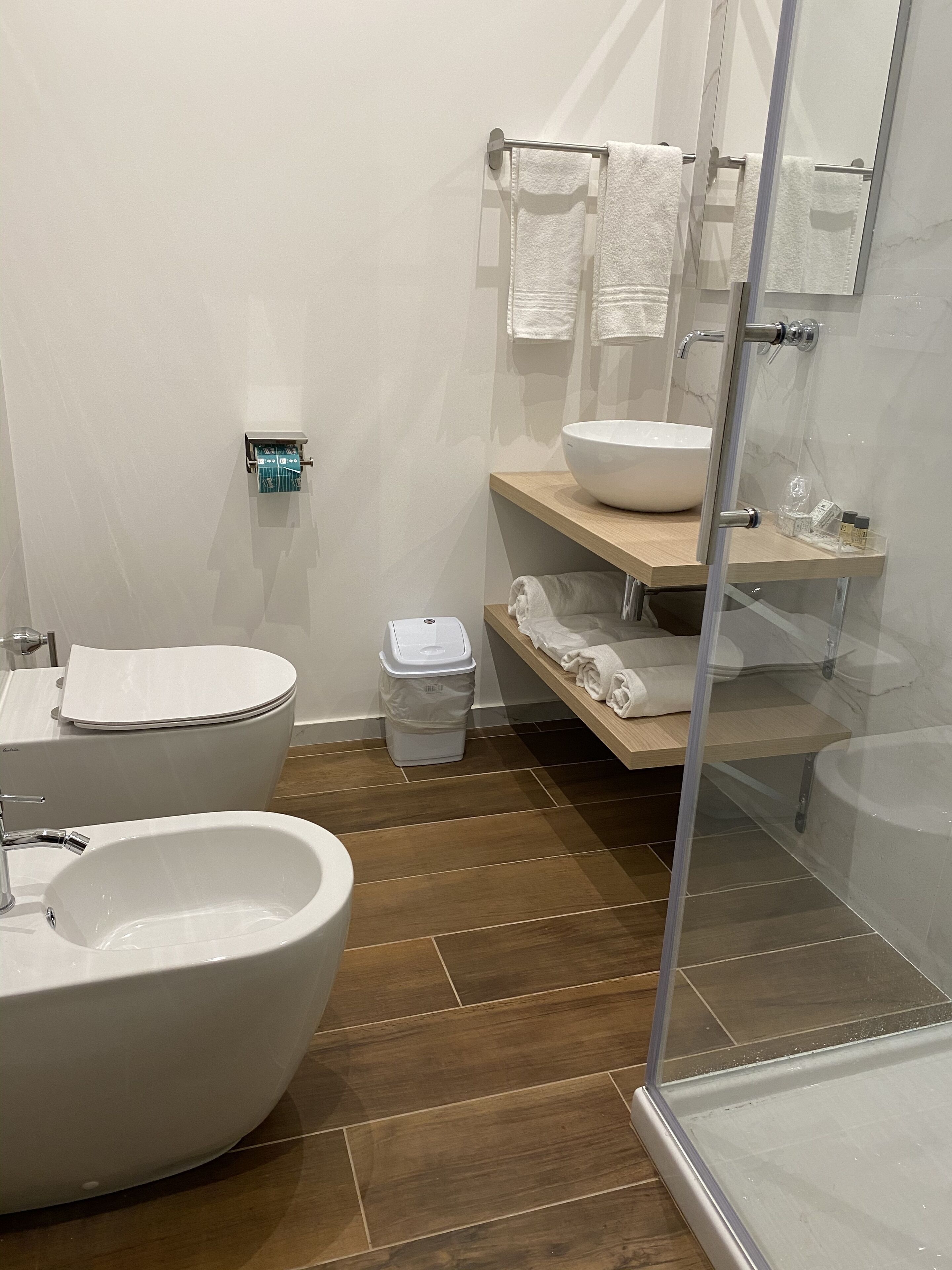 A modern bathroom with a freestanding bathtub, a large sink, and a toilet.