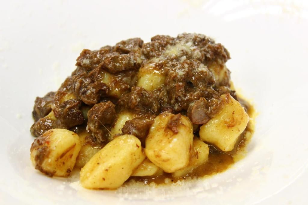 A dish with meat and potatoes.