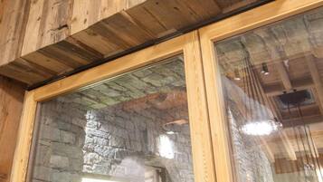 A wooden ceiling with exposed beams and a stone wall with a sign reading "TORANTE".