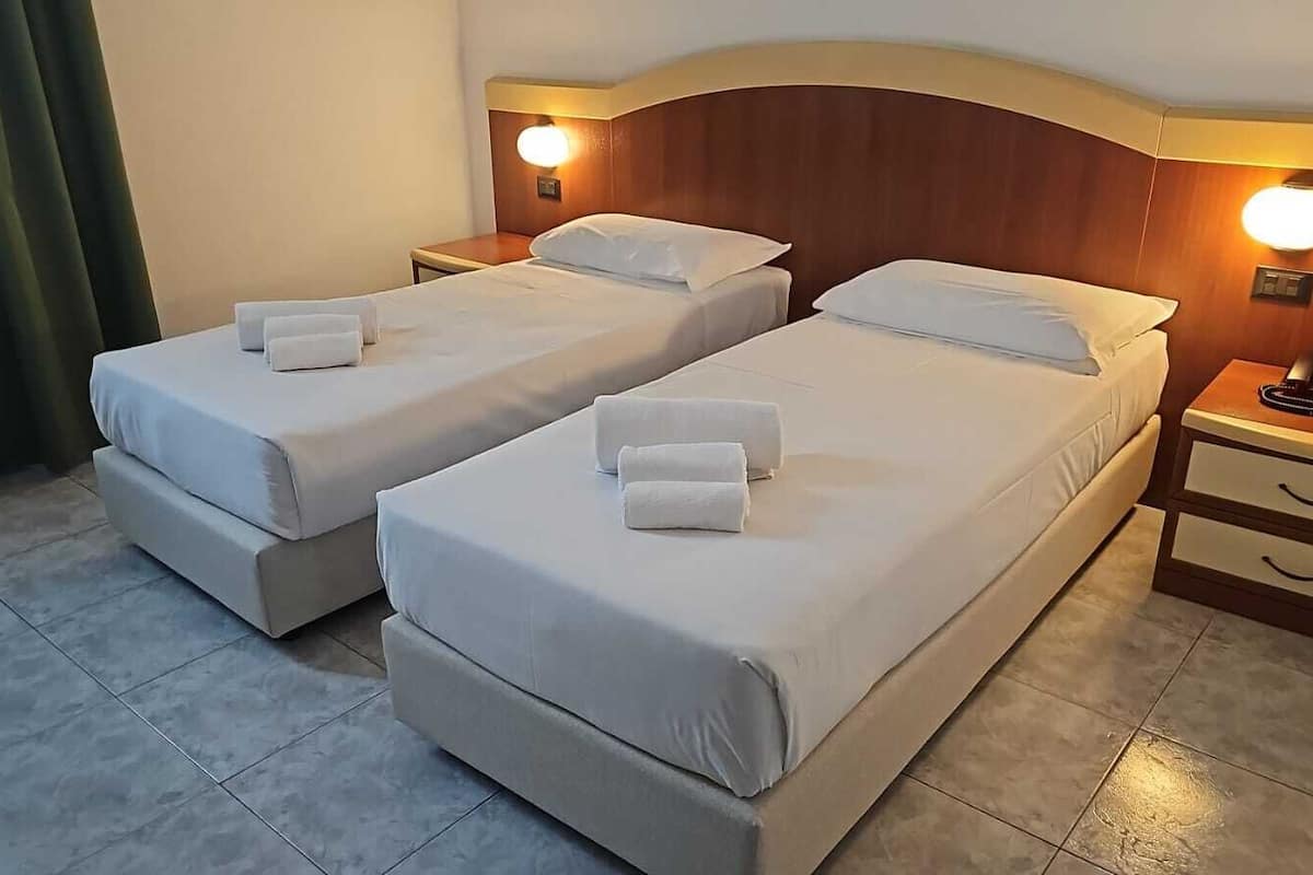 pillow-top beds, desk, laptop workspace, blackout curtains