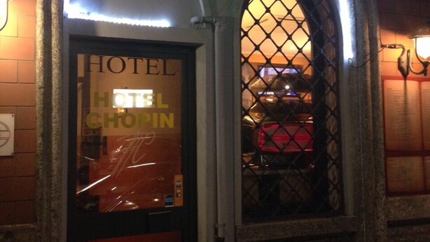 A hotel entrance with a neon sign reading "Hotel Chopin 143". - Hotel Chopin (Milan)