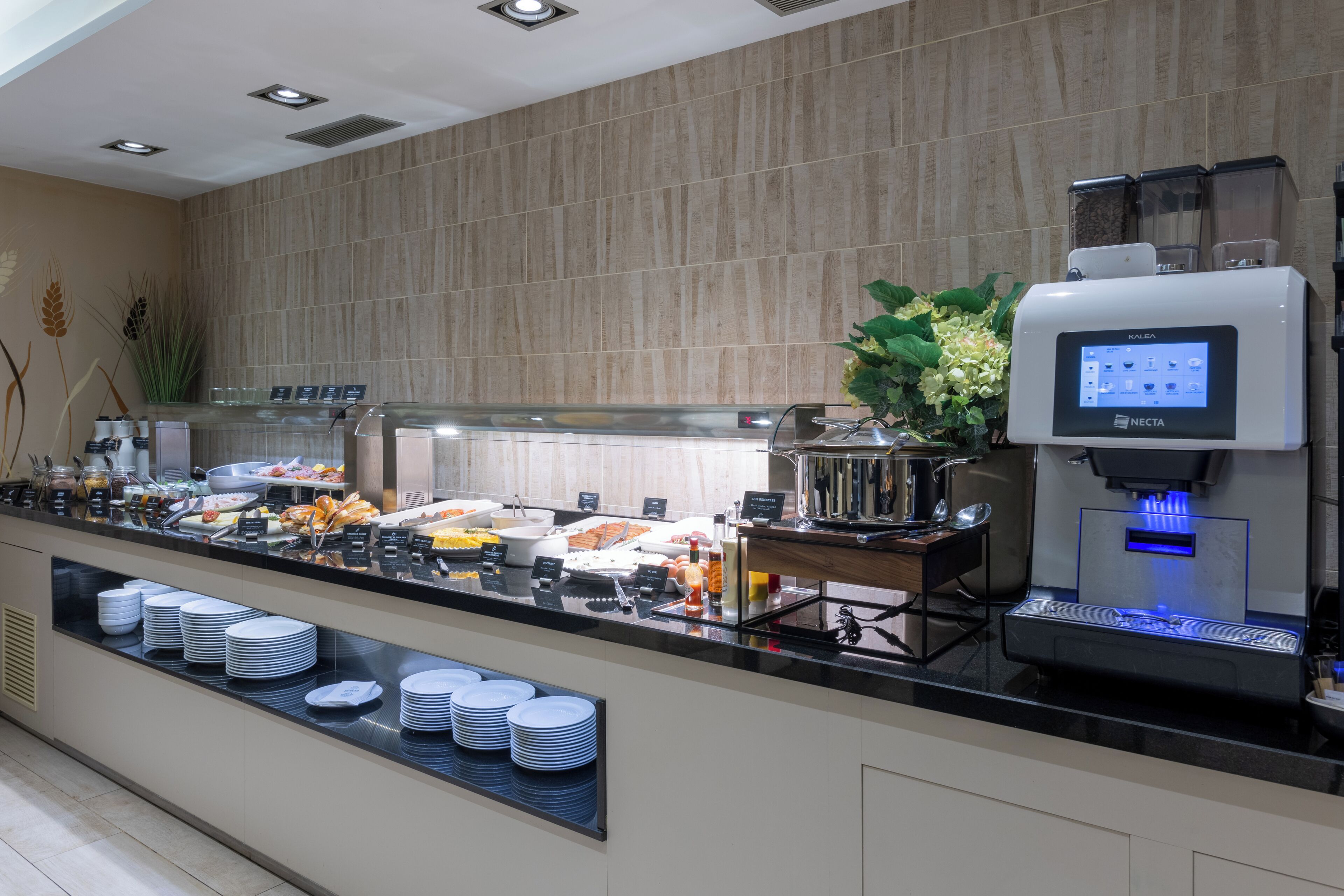 A buffet area with a self-service beverage station and a variety of food items.