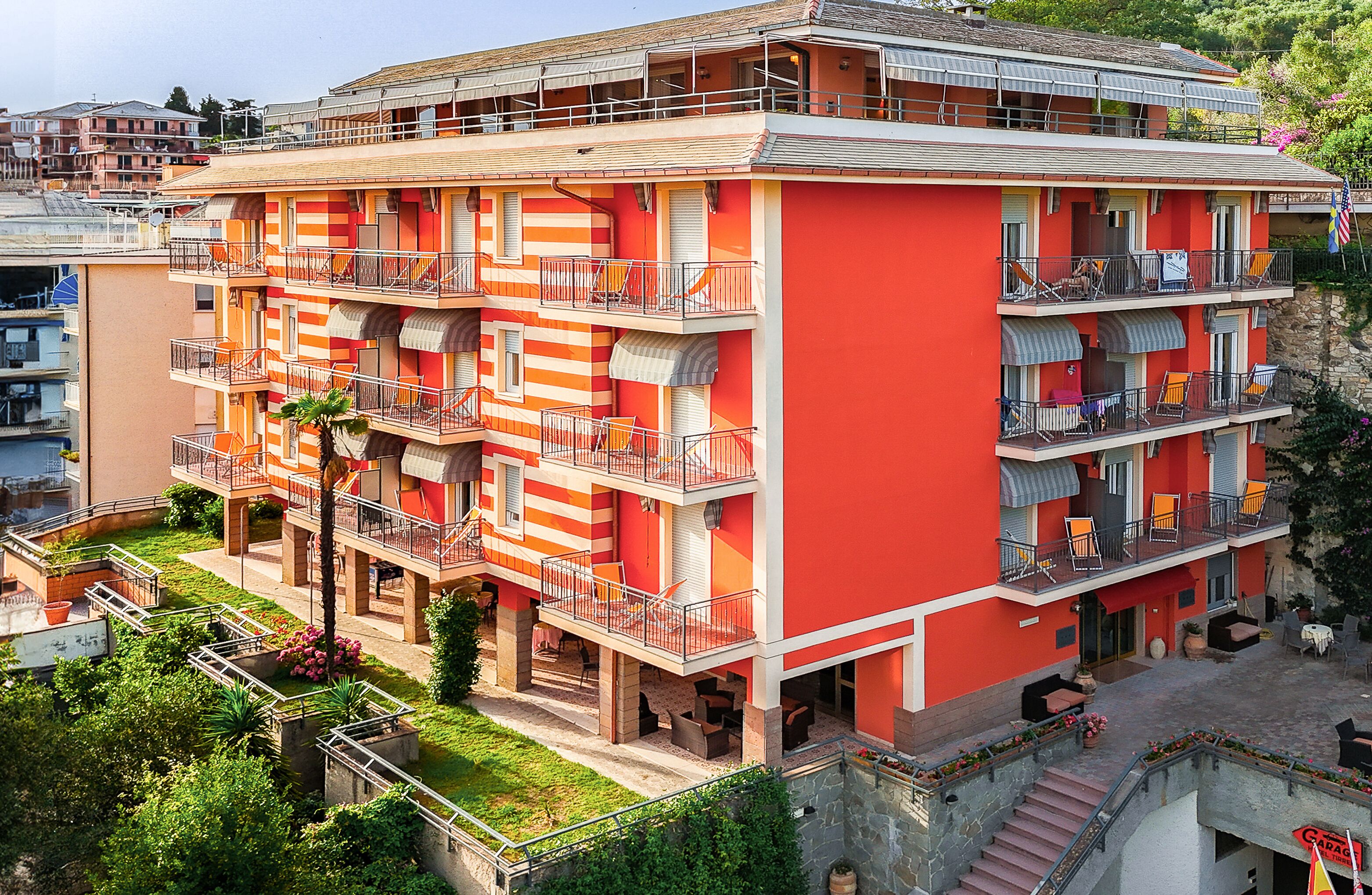 A multi-story building with balconies and outdoor seating areas.