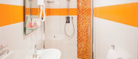 A bathroom with a shower, sink, and towel rack.