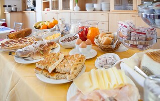 A breakfast buffet with various food items and beverages.