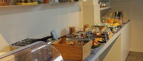 A buffet with various food items and condiments.