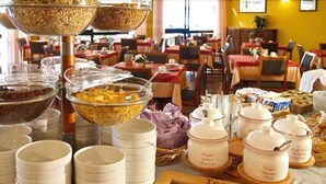 A buffet setup with various food items and serving dishes. - Hotel Anna (Malcesine)