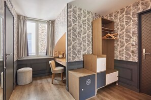 A compact room with a desk, chair, wardrobe, and a small stool. -  La Parizienne (Paris)