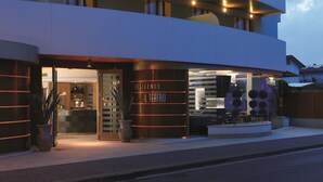 A modern building with a reception area and a sign reading "Residence Il Teatro".