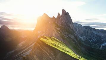 A mountainous landscape with prominent peaks and a valley.