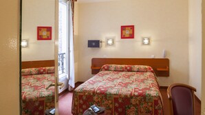 A hotel room with two beds, a chair, a small table, and a mirror. - Hôtel de la Place des Alpes (Paris)