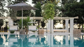 Seasonal outdoor pool, open 10:00 AM to 7:00 PM, pool umbrellas